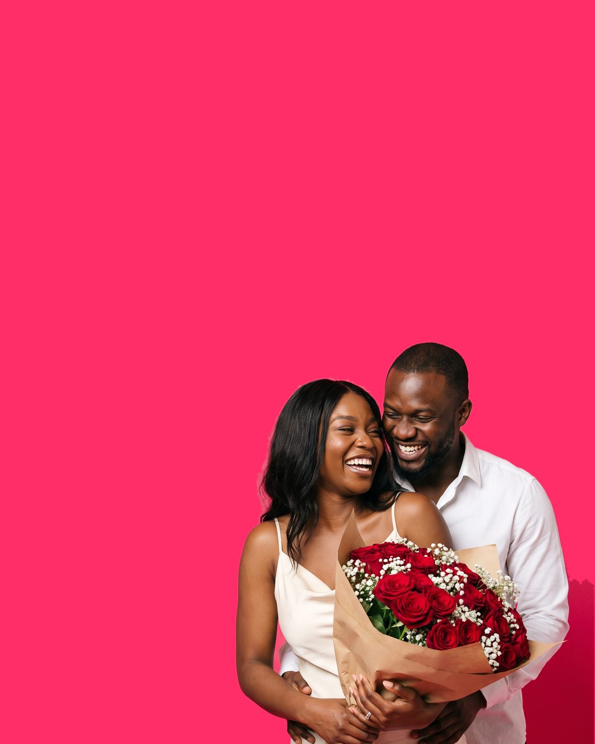 A couple laughing cheek to cheek, the woman in front holding deep red roses and white gypsophila