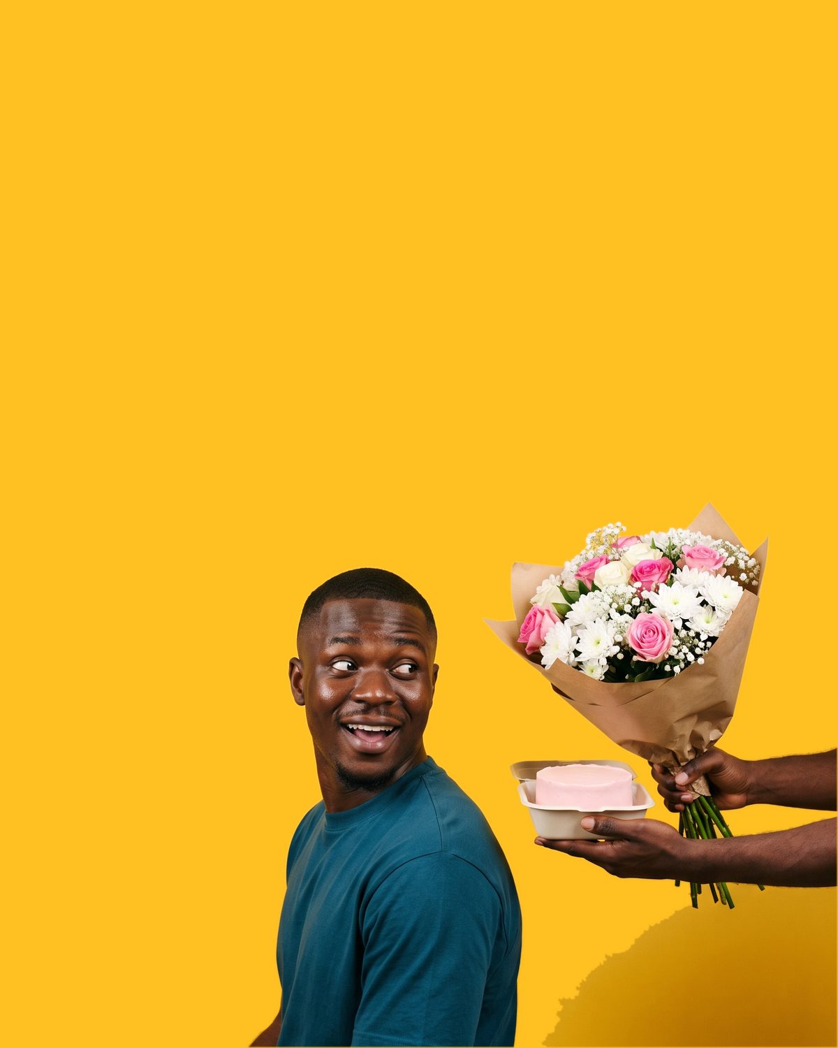 A man doing a double take as a small bento cake and a posy of flowers are handed to him from the edge of the frame